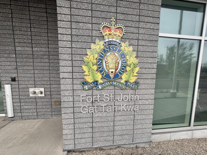 A photo of the RCMP's logo in front of their Fort St John detachment