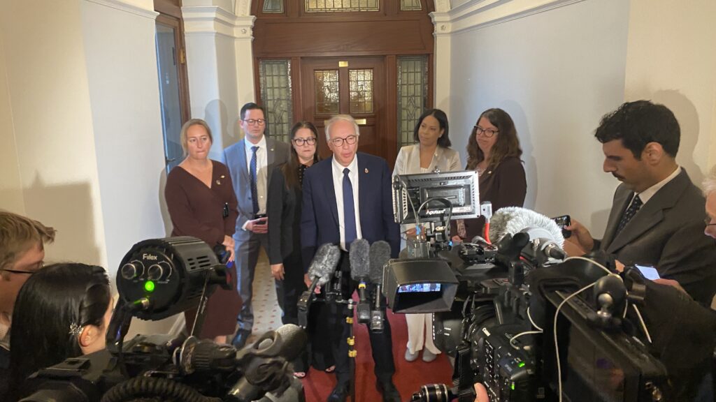 John Rustad speaks to reporters